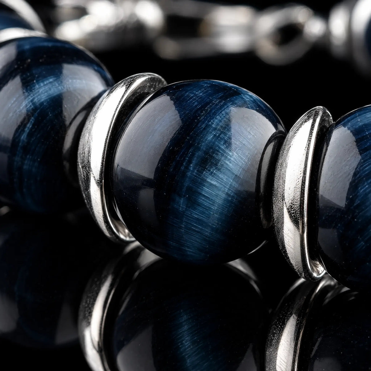 Macro detail of Blue Tiger Eye Bracelet V (10mm), showing the blue stone banding and silver spacers.