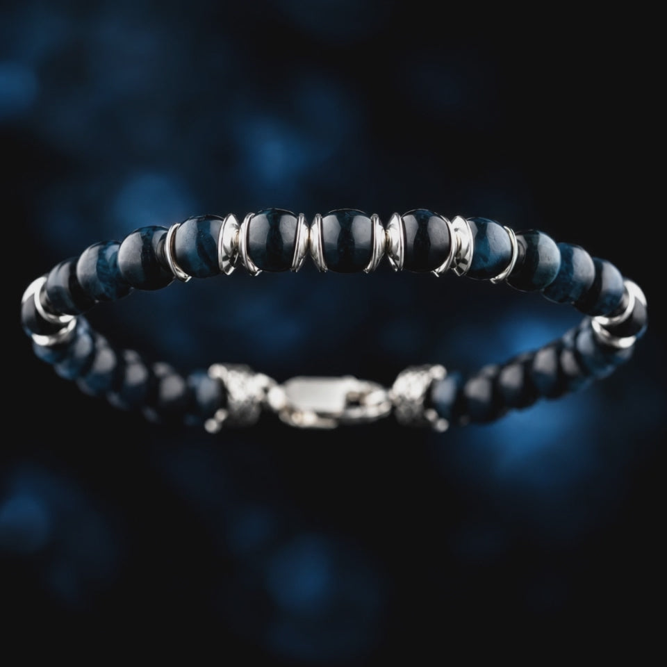 Detail video of Blue Tiger Eye Bracelet IV (6.5mm), showing blue stone banding and paired sculpted silver spacers.